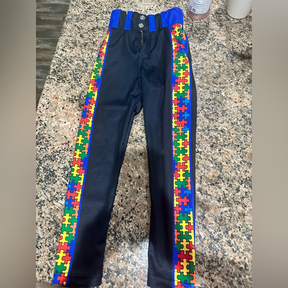 Custom Elite Boys youth Black Baseball Pants with Colorful Puzzle Pattern.